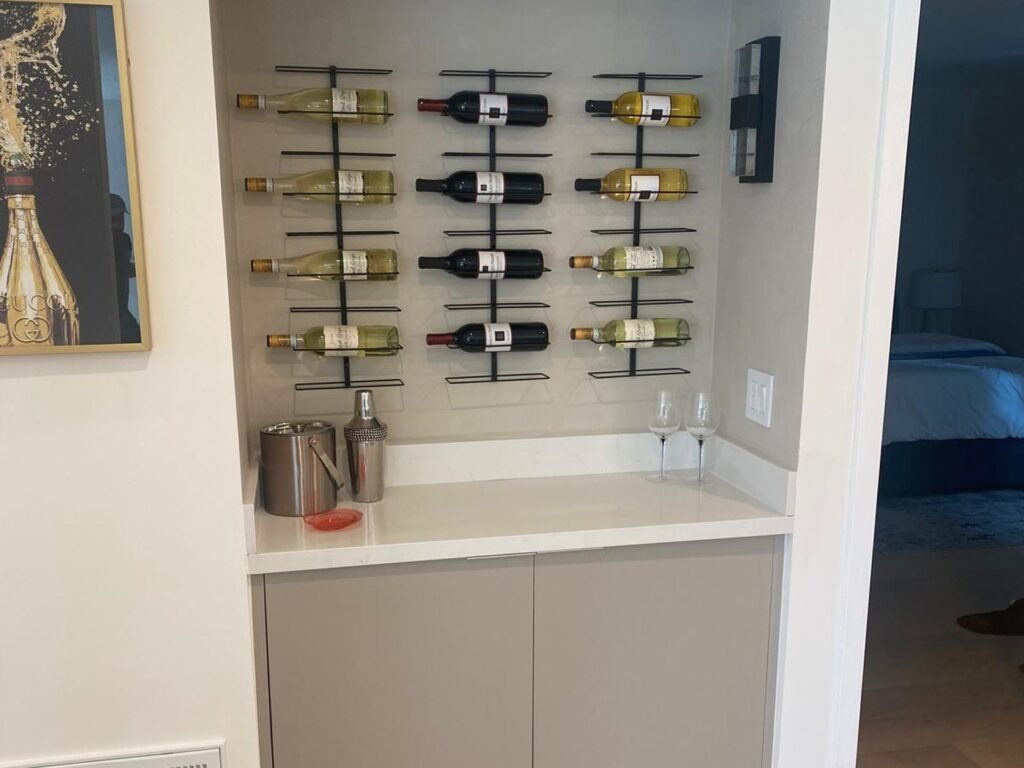 Built-in wine bar with a bottle display wall and a quartz counter