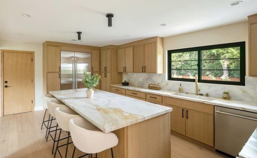 White oak kitchen with a quartzite island and marble backsplash